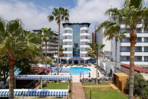 an image of a hotel with a pool and palm trees at Elysee Beach Hotel in Alanya +46 photos