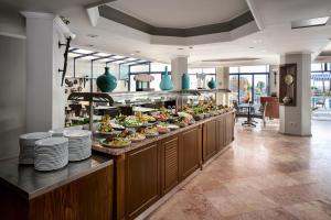 a buffet line with plates and bowls of food at Elysee Beach Hotel in Alanya
