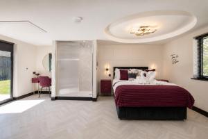 a bedroom with a large bed and a shower at Holly Tree Luxury Lodge in Skipwith +27 photos