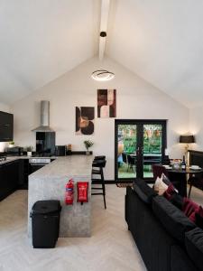 a kitchen and living room with a couch and a table at Holly Tree Luxury Lodge in Skipwith