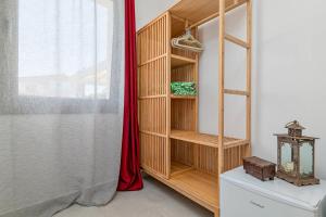 a room with a book shelf and a window at Ghjlgolu Suites - Essential Stay in Monte Petrosu
