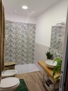 a bathroom with two sinks and two toilets at La casa di mamma in Monopoli +38 photos