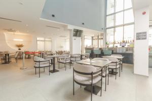 a dining room with tables and chairs in a restaurant at Garni Hotel MB Premium in Budva