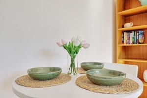 three bowls on a table with a vase of flowers at 1 bed, office space, private parking, contractors in Chelmsford