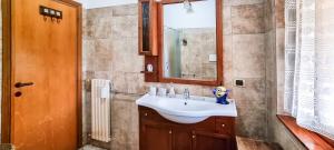 a bathroom with a sink and a mirror at Magic DaLu House in Olbia +21 photos