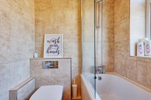 a bathroom with a tub and a toilet and a shower at 1 bed, office space, private parking, contractors in Chelmsford +20 photos