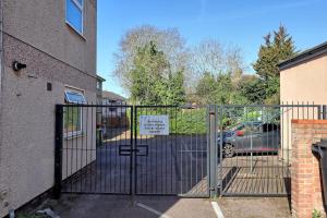 a gate with a sign on it next to a building at 1 bed, office space, private parking, contractors in Chelmsford