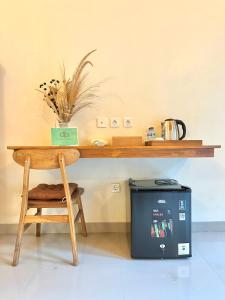 a wooden table with a trash can next to a table with a table at The Dulu Penida in Nusa Penida