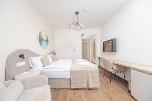 a hotel room with a bed and a couch at Garni Hotel MB Premium in Budva