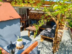 a patio with a couch and a table and chairs at Chata za Świerkami in Nowa Ruda