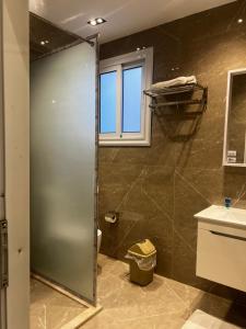 a bathroom with a shower and a toilet and a window at Regal view Aparthotel in Cairo +23 photos