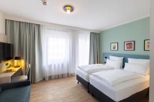 a bedroom with a large white bed and a couch at Hotel Continental Frankfurt in Frankfurt +84 photos