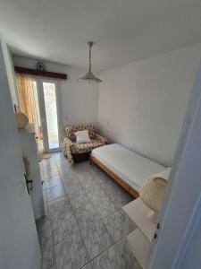 a small room with a bed and a couch at Dimitra House in Parga