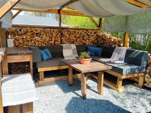 a patio with a couch and a table at Chata za Świerkami in Nowa Ruda