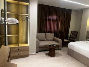 a hotel room with a bed and a couch at Regal view Aparthotel in Cairo