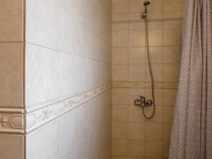 a bathroom with a shower with a shower curtain at Corfu Green Escape in Achílleion