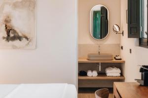 a bathroom with a sink and a mirror at La Chipirona Hotel in Valencia +45 photos