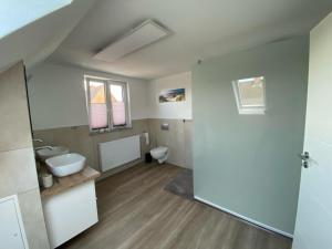 a bathroom with a toilet and a sink at Haus Dani in Oldenburg in Holstein +38 photos
