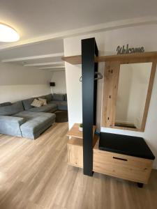 a living room with a couch and a large mirror at Haus Dani in Oldenburg in Holstein