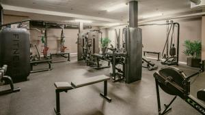 a gym with a bunch of equipment in a room at Apple Hotel & Konferens Göteborg in Gothenburg +85 photos