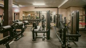 a gym with rows of equipment in a room at Apple Hotel & Konferens Göteborg in Gothenburg