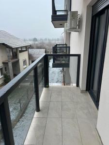 a balcony of a building with a view of a river at Sabac City Apartman Centar S2 in Šabac