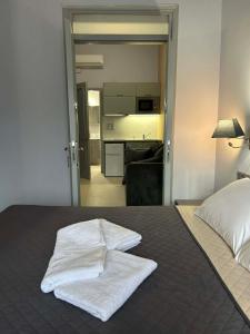 a bedroom with a bed with white towels on it at Amalize Luxury Apartments in Karistos