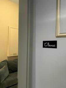 a door with a sign on it next to a couch at Amalize Luxury Apartments in Karistos