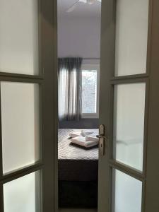 a door to a bedroom with a bed and a window at Amalize Luxury Apartments in Karistos