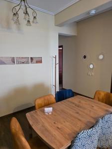 a dining room with a wooden table and chairs at Sherlock Home in Komotini