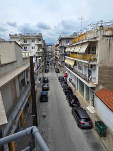 a view of a street with cars parked on the street at Sherlock Home in Komotini