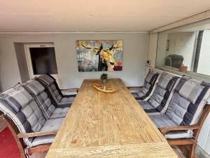 a dining room with a wooden table and chairs at Villa Topas in Wilhelmshaven +34 photos