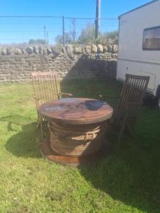 a picnic table and two chairs with a table and a table and chairs at Park house farm caravan 2 in Richmond +7 photos