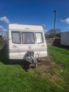 a white van parked in a field of grass at Park house farm caravan 2 in Richmond
