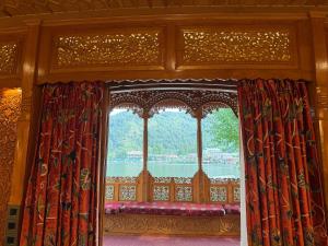 a window in a room with a view of the water at Suroor Houseboat in Srinagar