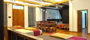 a dining room with a table and chairs at Moonlight Resorts Idappadi in Ammāpettai