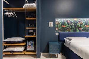 a bedroom with a blue accent wall and a bed at Taormina Town - Guesthouse Sicily in Taormina