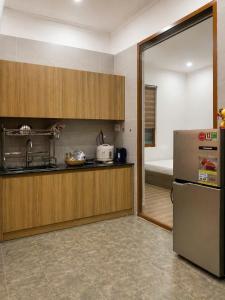 a kitchen with a stainless steel refrigerator and a sink at Góc Núi Homestay in Thôn Dư Khánh