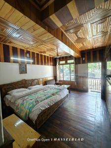 a bedroom with a large bed in a room with wooden walls at Mountain Orchid in Manāli +47 photos