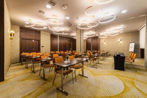 a conference room with tables and chairs in it at Hotel DeSilva Premium Opole in Opole