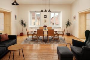 a living room with a table and chairs at Zámecký Hotel Litomyšl in Litomyšl