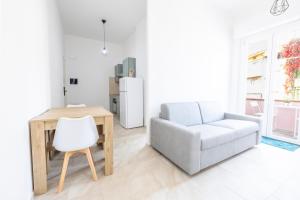 a living room with a couch and a table and a chair at Ischera Apartments in Guspini
