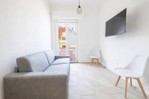 a living room with a couch and a chair at Ischera Apartments in Guspini