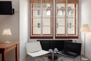 a room with a desk with a laptop and a chair at Zámecký Hotel Litomyšl in Litomyšl
