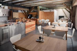 a restaurant with wooden tables and white chairs at Zámecký Hotel Litomyšl in Litomyšl +28 photos