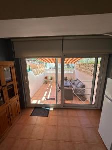 an open sliding glass door in a room with a patio at Casa Atalaya Playa R&R in Aguadulce