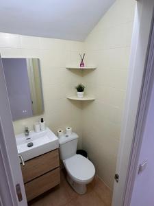 a bathroom with a toilet and a sink at Casa Atalaya Playa R&R in Aguadulce +6 photos