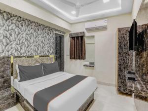 a bedroom with a large bed in a room at HOTEL Sarovar in Ahmedabad