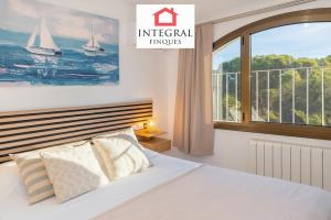 a bedroom with a bed and a large window at Casa Serena in Vall-Llobrega +45 photos