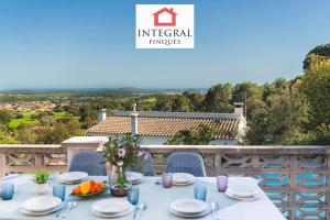 a table with plates and bowls of fruit on a balcony at Casa Serena in Vall-Llobrega
